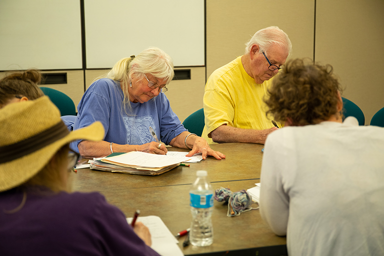 Community members writing during a poetry workshop.