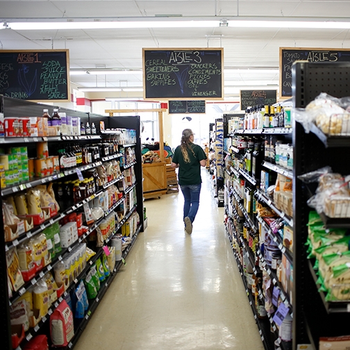 Community member walks down an aisle at Lost River Market and Deli in Paoli, Indiana.